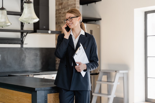 a%20real%20estate%20agent%20standing%20an%20property%20for%20sale%20talking%20on%20the%20phone a%20real%20estate%20agent%20standing%20an%20property%20for%20sale%20talking%20on%20the%20phone